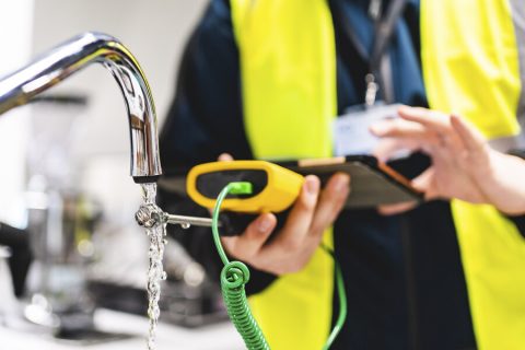 Close up of a water monitor testing water from a tap Close up of a water monitor testing water from a tap